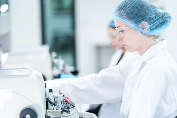 A technician prepares slides for a fully automated digital pathology workflow, where whole slide imaging and an AI algorithm will analyze the tissue for faster, more precise diagnostics.