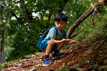 child hiking in forest with blue backpack, outdoor adventure