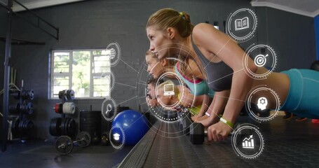 Four athletes syncing push-ups as camera dollying upward and HUD rotating capturing fitness data - Powered by Adobe