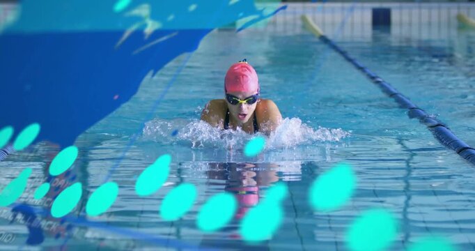 Mature woman initiating breaststroke cycle in lap pool, syncing data overlay with stroke metrics