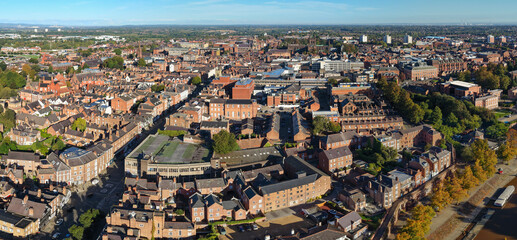 Aerial panorama of Chester cityscape with dense rooftops, historic buildings, and skyline views.