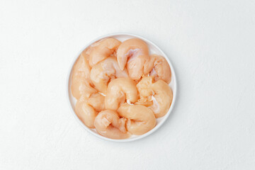 Fresh raw chicken breast fillet slices  with tomatoes salt and spices on black background