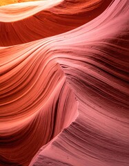 Obraz premium Intricate sandstone formations, swirling colors. Close-up view of reddish-pink rock layers