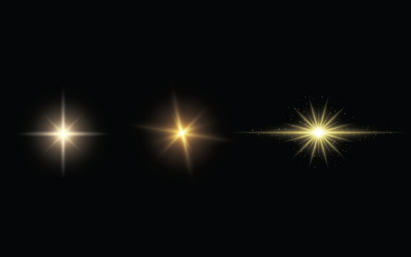 Three bright golden starburst light flares with emanating rays on a black background