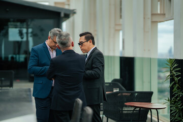 Executives networking in rooftop office space, highlighting teamwork, negotiation, and organizational leadership in modern corporate culture.