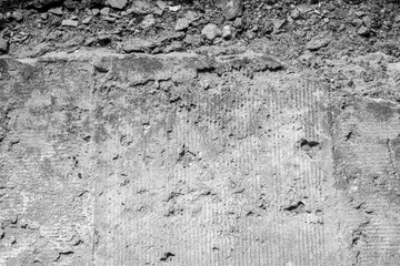 Black-and-white concrete erosion vignette for concept of decay and structural aging