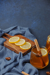 Citrus slices and spiced drink with cinnamon sticks and star anise on rustic wood