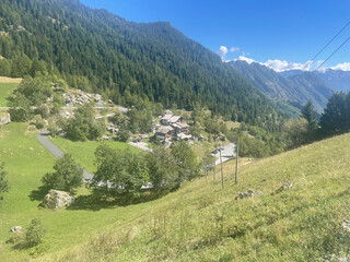 Scenic mountain landscape in the Champorcher Valley, located within the Mont Avic Natural Park in the Aosta Valley, Italy. A small alpine village