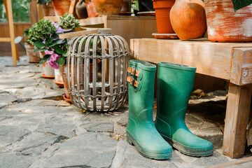 Artistic floral arrangement with hydrangeas and rubber boots for gardening and floral styling