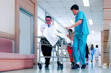 Team medical staff pushing stretcher gurney bed with injured patient to emergency room in hospital....