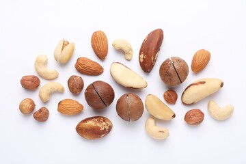 Mix of different nuts on white background, flat lay