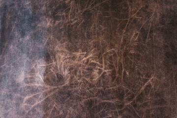 Closeup of brown distressed leather texture for vintage material background and design detail