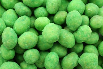 Tasty wasabi coated peanuts as background, closeup
