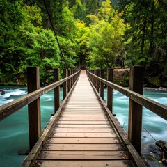 Obraz premium Wooden suspension bridge spanning a rushing river, through a lush forest