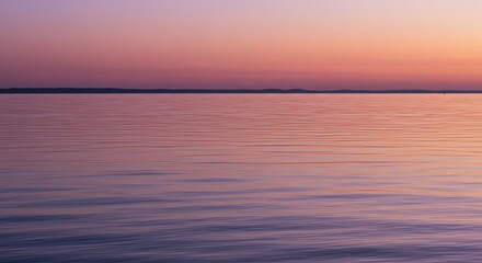 Fototapeta premium Serene lake water reflects vibrant sunset hues creating a peaceful natural backdrop