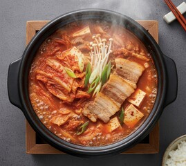 Pork Belly Kimchi Jjigae (삼겹살 김치찌개) Boiling in a Red Broth
