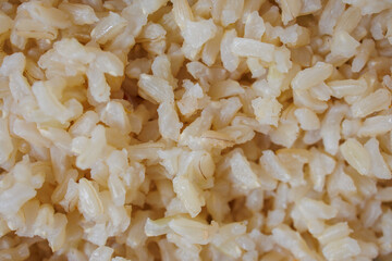 Boiled brown rice closeup, healthy food background with organic grains for vegan diet