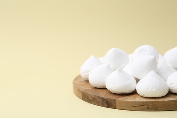 Yummy meringue cookies on beige background, closeup. Space for text