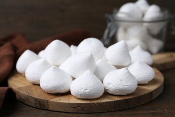Yummy meringue cookies on wooden table, closeup