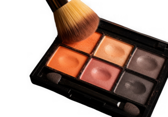 Warm toned eyeshadow palette with makeup brush on black background