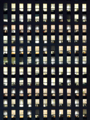 Office building exterior in the late evening with interior lights on