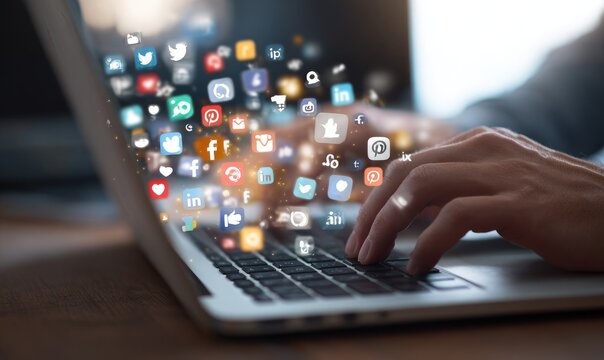 Hands typing on a laptop with social media icons flying around - Powered by Adobe