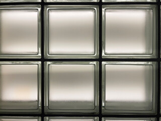 Frosted glass block wall pattern with square tiles, modern architectural interior design element, background texture for construction, privacy screen, building decor, lighting diffusion, and abstract 