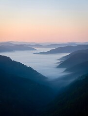 Fototapeta premium Misty mountain range at sunrise creating a tranquil and serene landscape view