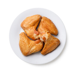 Smoked chicken wings on a plate on a white. Top view