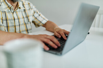 Fototapeta premium Portrait of a young man with laptop at home