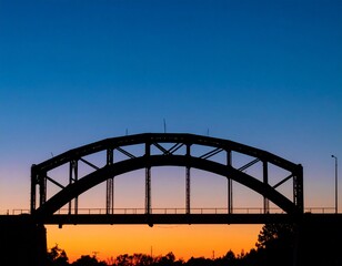 Minimalistic composition of single abandoned railway bridge arch silhouetted against twilight gradient sky