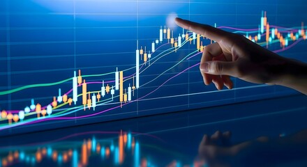 A hand points at a stock market chart with candlesticks and colorful lines on a blue background screen