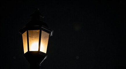 Lonely Old Fashioned Streetlight Illuminating a Dark Black Night with Copy Space