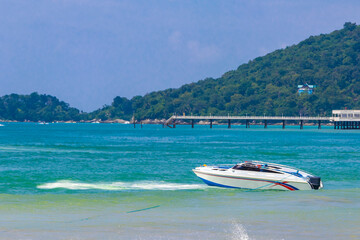 Patong Beach Phuket with turquoise blue water and boat Thailand.