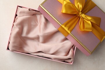 Open gift box with beautiful lid on light background, top view