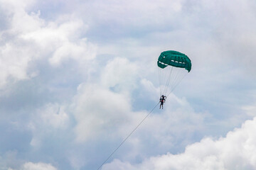 Patong Beach Phuket with turquoise blue water and parasailing Thailand.