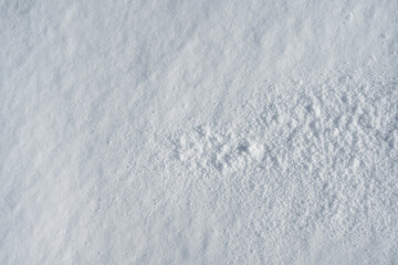 Untouched smooth snow surface with soft natural texture and sparkles in sunligh