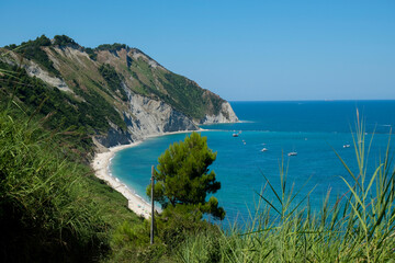 Sunny day at the cliffs in Marche, Italy. Coastline, horizontal line, natural background. turquoise water	
