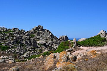 Rocky coastline of Capo Testa in Sardinia, Italy. Hiking trail, granite rocks and cloudless sunny sky. 