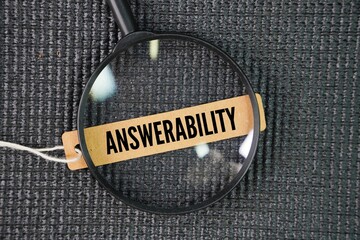 Magnifying glass and paper tag with the word answerability. responsibility for explaining or...