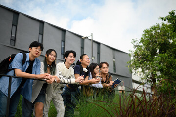 A group of LGBTQ university students leans against a railing, smiling and looking forward, Embracing Diversity and Future Possibilities