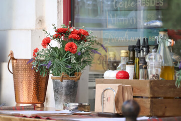 A bouquet of autumn flowers and reflections in the restaurant window.