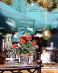 A bouquet of autumn flowers and reflections in the restaurant window.