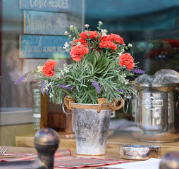 A bouquet of autumn flowers and reflections in the restaurant window.