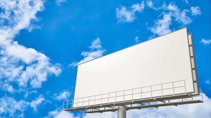 Empty outdoor advertising billboard with a vast white blank space against a brilliant blue sky and...