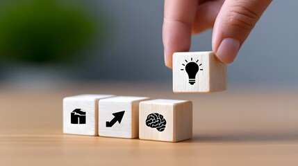 Hand arranging wooden blocks with icons representing innovation, creativity, problem-solving, and the thought process behind finding solutions and ideas