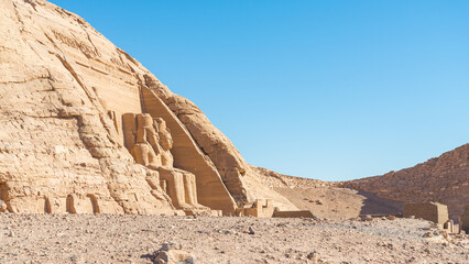 The famous archeological site named "Abu Simbel", Egypt, with the big statues made of stone of pharaoh Ramesses the second. Blue sky on the background.