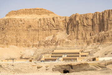 Queen Hatshepsut mortuary temple in Luxor, Egypt. Landscape view with rock wall and blue sky on the background.