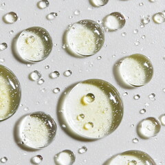 transparent skincare gel or oil blobs and droplets scattered across a clean