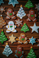 Decorated gingerbread cookies arranged on wooden table. Christmas mood, food